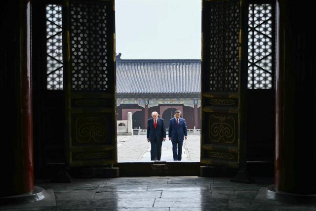 China's President Xi Jinping (R) and US President Donald Trump visit the Temple of Heaven in Beijing on May 14, 2026. Xi warned Trump that the issue of Taiwan could push their two countries into "conflict" if mishandled, a stark opening salvo as a superpower summit set to tackle numerous thorny issues began in Beijing on May 14. (Photo by Brendan SMIALOWSKI / POOL / AFP)