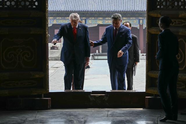 China's President Xi Jinping (R) and US President Donald Trump visit the Temple of Heaven in Beijing on May 14, 2026. Xi warned Trump that the issue of Taiwan could push their two countries into "conflict" if mishandled, a stark opening salvo as a superpower summit set to tackle numerous thorny issues began in Beijing on May 14. (Photo by Brendan SMIALOWSKI / POOL / AFP)