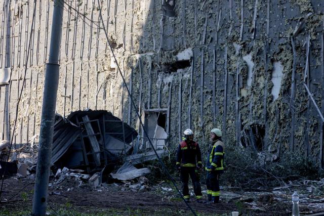 Rescuers and first responders operate at the site of a partially destroyed residential building following Russian drone and missile strikes in Kyiv on May 14, 2026, amid the Russian invasion of Ukraine. Russia launched more than 670 drones and 56 missiles at Ukraine overnight, Ukraine's President announced on May 14, 2026. (Photo by Tetiana DZHAFAROVA / AFP)
