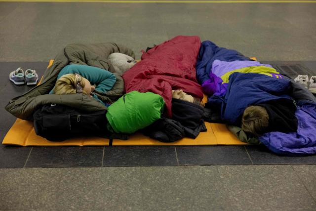 Local residents sleep in sleeping bags during an air alarm as they take shelter at a subway station in Kyiv on May 14, 2026, amid the Russian invasion in Ukraine. Ukraine's capital came under heavy aerial attack early on May 14, an AFP journalist reported, as Kyiv's mayor said Russia was striking the city. (Photo by Tetiana DZHAFAROVA / AFP)