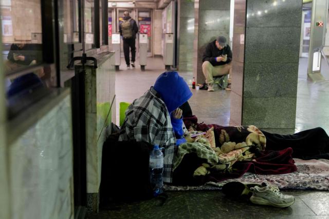 A local resident waits for the end of an air alarm taking shelter at a subway station in Kyiv on May 14, 2026, amid the Russian invasion in Ukraine. Ukraine's capital came under heavy aerial attack early on May 14, an AFP journalist reported, as Kyiv's mayor said Russia was striking the city. (Photo by Tetiana DZHAFAROVA / AFP)