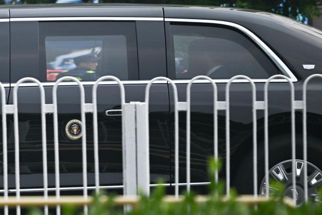 The motorcade of US President Donald Trump arrives back at the hotel in Beijing on May 14, 2026. (Photo by Pedro PARDO / AFP)