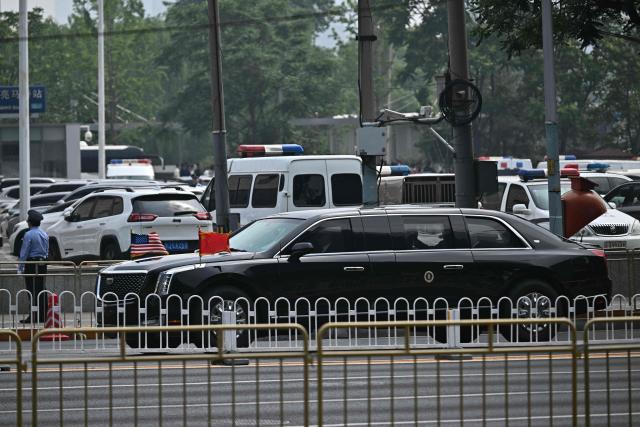 The motorcade of US President Donald Trump arrives back at the hotel in Beijing on May 14, 2026. (Photo by Pedro PARDO / AFP)