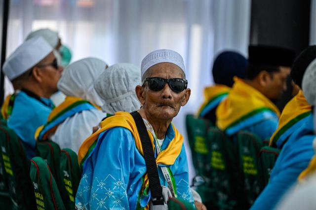A prospective Indonesian hajj pilgrim looks on as they gather for a pre-departure safety training session at the hajj embarkation centre in Banda Aceh on May 14, 2026. (Photo by CHAIDEER MAHYUDDIN / AFP)
