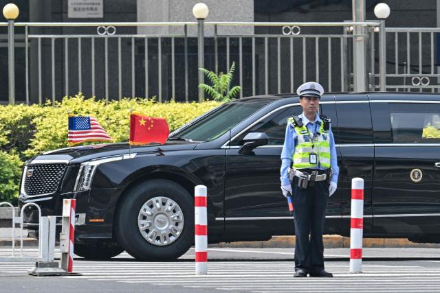 The motorcade of US President Donald Trump arrives back at the hotel in Beijing on May 14, 2026. (Photo by HECTOR RETAMAL / AFP)