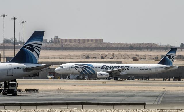 (FILES) EgyptAir planes are seen on the tarmac at Cairo international airport on May 19, 2016 after an EgyptAir flight from Paris to Cairo crashed into the Mediterranean on with 66 people on board, prompting an investigation into whether it was mechanical failure or a bomb. Ten years after the deaths of 66 people, including 15 French nationals, in the EgyptAir crash in the Mediterranean, the Paris public prosecutor's office has recommended that the case be dropped on the grounds that the investigation "has not identified any negligence other than that" of the crew members, all of whom died, AFP learned on May 14, 2026, from a source close to the case. (Photo by KHALED DESOUKI / AFP)