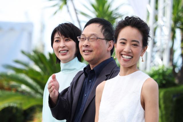 (FROM L) Japanese actress Takako Matsu, Japanese director and screenwriter Koji Fukada and Japanese actress Shizuka Ishibashi pose during a photocall of the film "Nagi Notes" at the 79th edition of the Cannes Film Festival in Cannes, southern France on May 14, 2026. (Photo by Valery HACHE / AFP)