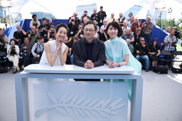 (FROM L) Japanese actress Shizuka Ishibashi, Japanese director and screenwriter Koji Fukada and Japanese actress Takako Matsu pose during a photocall of the film "Nagi Notes" at the 79th edition of the Cannes Film Festival in Cannes, southern France on May 14, 2026. (Photo by Valery HACHE / AFP)