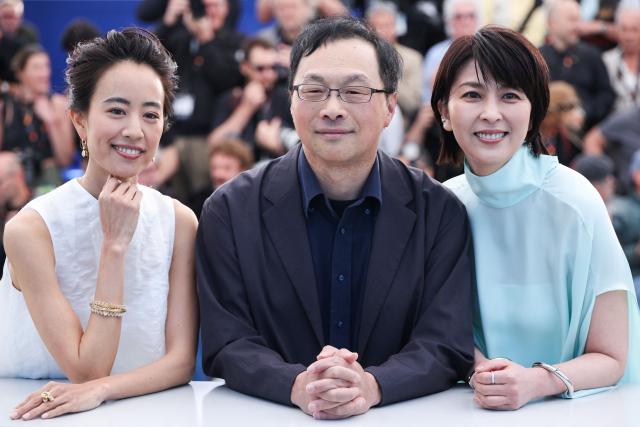 (FROM L) Japanese actress Shizuka Ishibashi, Japanese director and screenwriter Koji Fukada and Japanese actress Takako Matsu pose during a photocall of the film "Nagi Notes" at the 79th edition of the Cannes Film Festival in Cannes, southern France on May 14, 2026. (Photo by Valery HACHE / AFP)