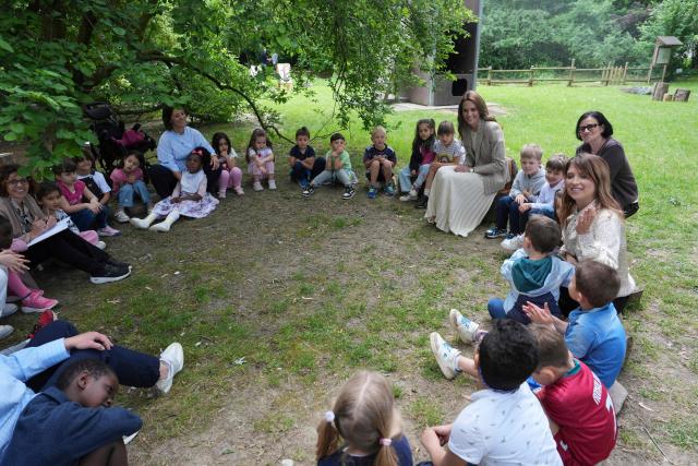 Britain's Catherine, Princess of Wales sits with children during her visits to the Salvador Allende preschool to observe how nature-based learning is embedded within the Reggio Emilia approach, part of a two-day trip, in Reggio Emilia, Italy, on May 14, 2026. Established in 1996, REMIDA is a cultural project dedicated to sustainability, creativity and the re use of industrial surplus. (Photo by Antonio Calanni / POOL / AFP)