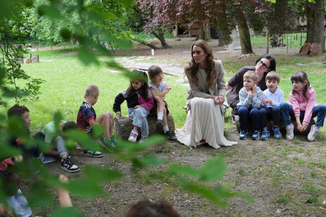 Britain's Catherine, Princess of Wales sits with children during her visits to the Salvador Allende preschool to observe how nature-based learning is embedded within the Reggio Emilia approach, part of a two-day trip, in Reggio Emilia, Italy, on May 14, 2026. Established in 1996, REMIDA is a cultural project dedicated to sustainability, creativity and the re use of industrial surplus. (Photo by Antonio Calanni / POOL / AFP)