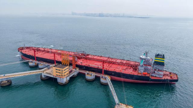 This aerial photo shows a tanker unloading imported crude oil at a terminal port in Qingdao, in China’s eastern Shandong province on May 14, 2026. (Photo by CN-STR / AFP) / China OUT