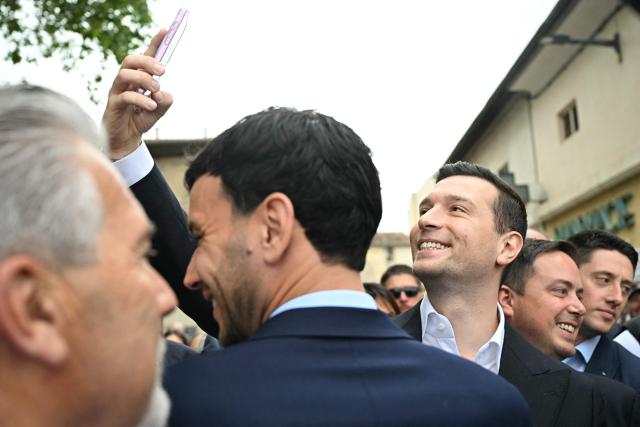 French far-right party Rassemblement National (RN) president Jordan Bardella poses for a selfie during a visit in Beaucaire, southern France on May 14, 2026. (Photo by Gabriel BOUYS / AFP)