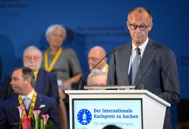 German Chancellor Friedrich Merz gives a speech during a ceremony to award the former President of the European Central Bank (ECB) and former Italian Prime Minister Mario Draghi (not in picture) with the 2026 International Charlemagne Prize of Aachen, on May 14, 2026 in Aachen, western Germany. (Photo by Sascha Schuermann / AFP)
