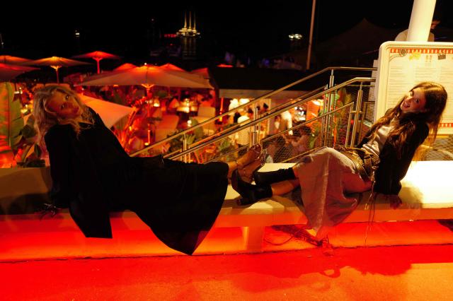 Festival goers pose on the Boulevard de la Croisette on the sidelines at the 79th edition of the Cannes Film Festival in Cannes, southern France on May 13, 2026. (Photo by Valery HACHE / AFP)