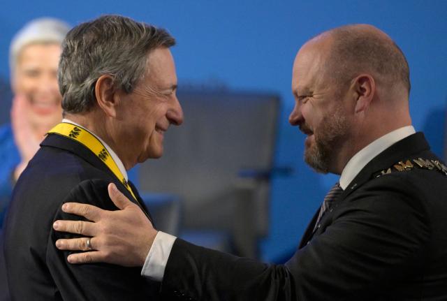 The former President of the European Central Bank (ECB) and former Italian Prime Minister Mario Draghi (L) is awarded with the 2026 International Charlemagne Prize of Aachen by Aachen's mayor Michael Ziemons on May 14, 2026 in Aachen, western Germany. (Photo by Sascha Schuermann / AFP)