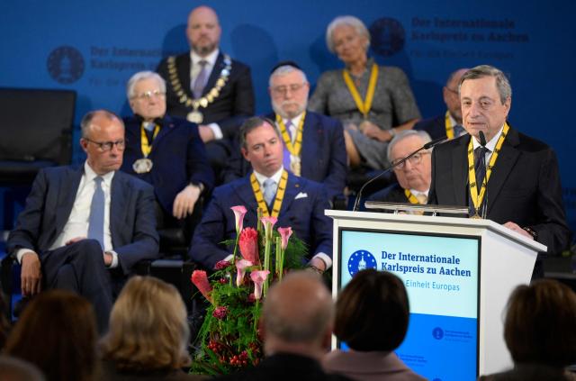 The former President of the European Central Bank (ECB) and former Italian Prime Minister Mario Draghi (R) gives a speech as he is awarded the 2026 International Charlemagne Prize of Aachen, on May 14, 2026 in Aachen, western Germany. (Photo by Sascha Schuermann / AFP)