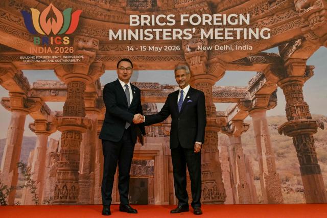India's Foreign Minister Subrahmanyam Jaishankar (R) shakes hands with Kazakhstan's First Deputy Foreign Minister Yerzhan Ashikbayev during the BRICS Foreign Ministers’ meeting at the Bharat Mandapam in New Delhi on May 14, 2026. (Photo by Arun SANKAR / AFP)