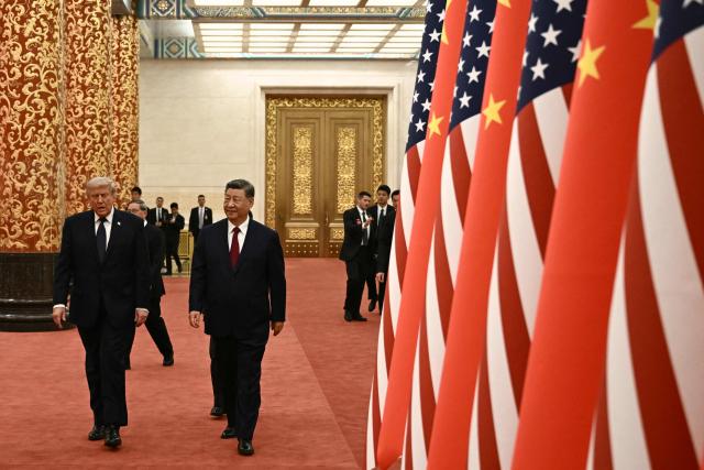 TOPSHOT - China's President Xi Jinping (R) and US President Donald Trump arrive to attend a state banquet at the Great Hall of the People in Beijing on May 14, 2026. (Photo by Brendan SMIALOWSKI / AFP)