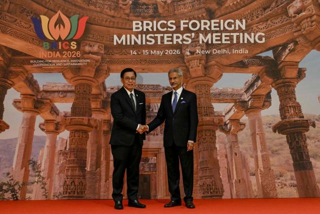 India's Foreign Minister Subrahmanyam Jaishankar (R) shakes hands with Thailand's Deputy Prime Minister and Foreign Minister Sihasak Phuangketkeow during the BRICS Foreign Ministers’ meeting at the Bharat Mandapam in New Delhi on May 14, 2026. (Photo by Arun SANKAR / AFP)