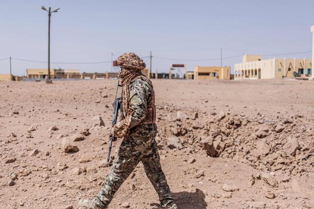 A soldier from the National Front for the Liberation of Azawad (FLA) inspects the site of a crater in Kidal on May 14, 2026 caused by aerial bombardment from Malian Armed Forces (FAMA). Strategic towns, including Kidal in the desert north, and Kati, a garrison town near the capital Bamako, were targeted in the April 25 and 26 offensive. Kidal and other towns and villages in the north were captured and are now under the control of the FLA and the jihadists, who have since imposed a blockade on Bamako that continued to disrupt transport. (Photo by AFP)