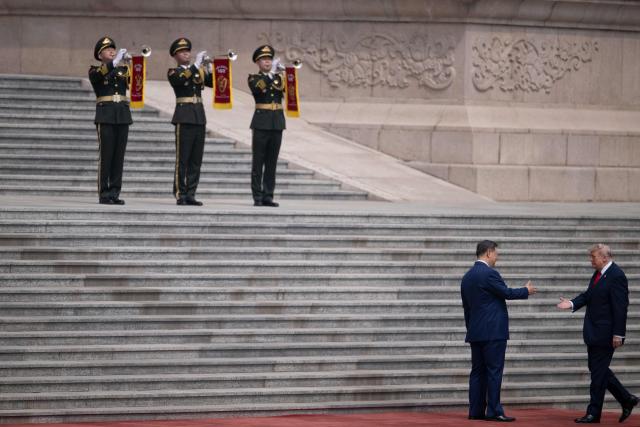 US President Donald Trump (R) shakes hands with China's President Xi Jinping during a welcome ceremony at the Great Hall of the People in Beijing on May 14, 2026. (Photo by Brendan Smialowski / AFP)