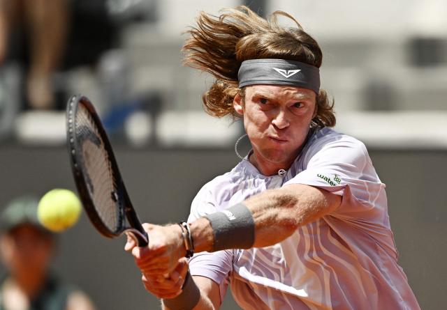 Russia's Andrey Rublev hits a return to Italy's Jannik Sinner during the ATP Rome Open tennis tournament at Foro Italico in Rome on May 14, 2026. (Photo by Tiziana FABI / AFP)