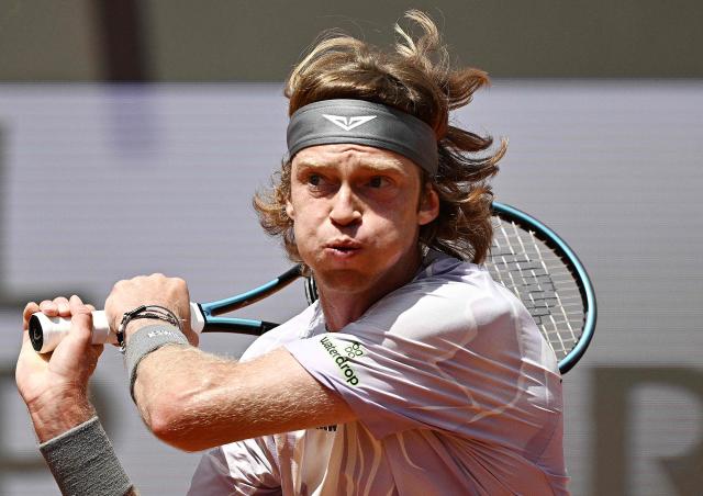 Russia's Andrey Rublev hits a return to Italy's Jannik Sinner during the ATP Rome Open tennis tournament at Foro Italico in Rome on May 14, 2026. (Photo by Tiziana FABI / AFP)