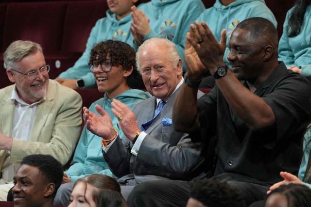 Britain's King Charles III alongside British actor Idris Elba, meets students taking part in National Youth Music Theatre workshops in south west London on May 14, 2026, to celebrate the 50th anniversary of the arts organisation. (Photo by Kin Cheung / POOL / AFP)