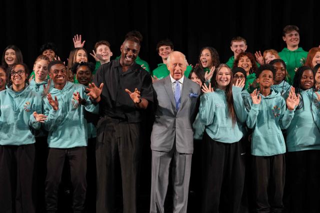 Britain's King Charles III alongside British actor Idris Elba, meets students taking part in National Youth Music Theatre workshops in south west London on May 14, 2026, to celebrate the 50th anniversary of the arts organisation. (Photo by Kin Cheung / POOL / AFP)