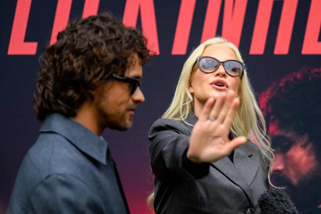 Finnish singers Linda Lampenius (R) and Pete Parkkonen, representing Finland with the song 'Liekinheitin' give an interview on the sidelines of the Eurovision Song Contest 2026 (ESC) in Vienna, Austria on May 14, 2026, before the second semi-final of the contest. (Photo by MAX SLOVENCIK / APA / AFP) / Austria OUT