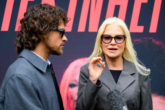Finnish singers Linda Lampenius (R) and Pete Parkkonen, representing Finland with the song 'Liekinheitin' give an interview on the sidelines of the Eurovision Song Contest 2026 (ESC) in Vienna, Austria on May 14, 2026, before the second semi-final of the contest. (Photo by MAX SLOVENCIK / APA / AFP) / Austria OUT
