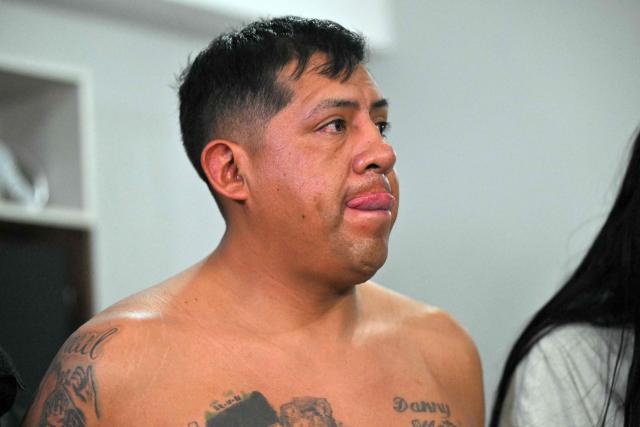 Police arrest Eduardo Gomez, alias "Gordo Paul", a leader of Los Lobos drug trafficking group, during a curfew imposed by Ecuador's President Daniel Noboa to tackle organized crime, in Quito in the early hours of May 14, 2026. Ecuador's police on May 14 captured a "dangerous" leader of Los Lobos, the country's largest drug trafficking group, in a cinematic operation led by Interior Minister Jhon Reimberg, AFP reporters witnessed. (Photo by Rodrigo BUENDIA / AFP)