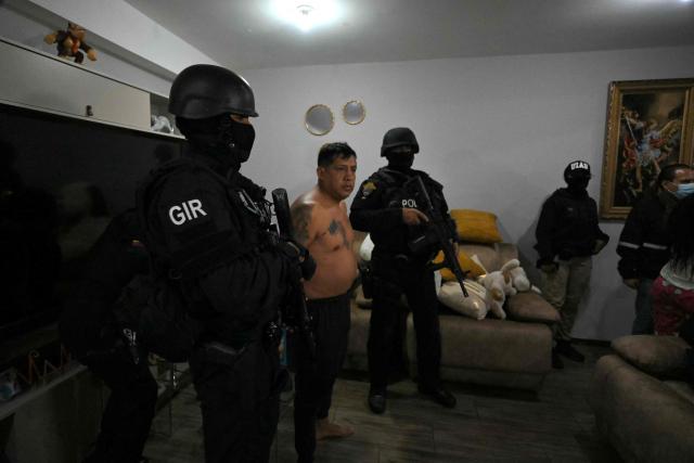 Police arrest Eduardo Gomez, alias "Gordo Paul", a leader of Los Lobos drug trafficking group, during a curfew imposed by Ecuador's President Daniel Noboa to tackle organized crime, in Quito in the early hours of May 14, 2026. Ecuador's police on May 14 captured a "dangerous" leader of Los Lobos, the country's largest drug trafficking group, in a cinematic operation led by Interior Minister Jhon Reimberg, AFP reporters witnessed. (Photo by Rodrigo BUENDIA / AFP)