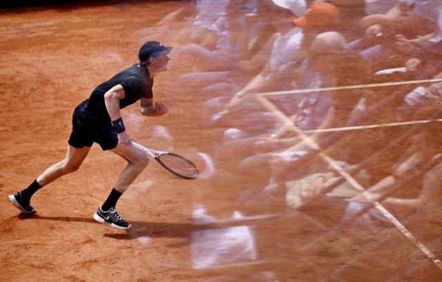 Member's of the public are reflected in a window as Italy's Jannik Sinner plays against Russia's Andrey Rublev during the ATP Rome Open tennis tournament at Foro Italico in Rome on May 14, 2026. (Photo by Tiziana FABI / AFP)