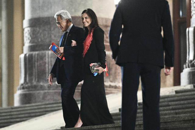 Nvidia founder and CEO Jensen Huang (L) and a guest leave after a state banquet for US President Donald Trump and China's President Xi Jinping at the Great Hall of the People in Beijing on May 14, 2026. (Photo by Brendan SMIALOWSKI / AFP)