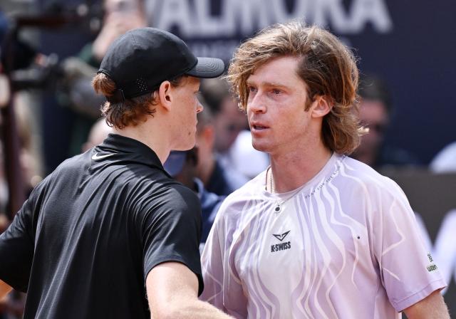 Italy's Jannik Sinner (L) embraces Russia's Andrey Rublev at the end of the match during the ATP Rome Open tennis tournament at Foro Italico in Rome on May 14, 2026. (Photo by Tiziana FABI / AFP)