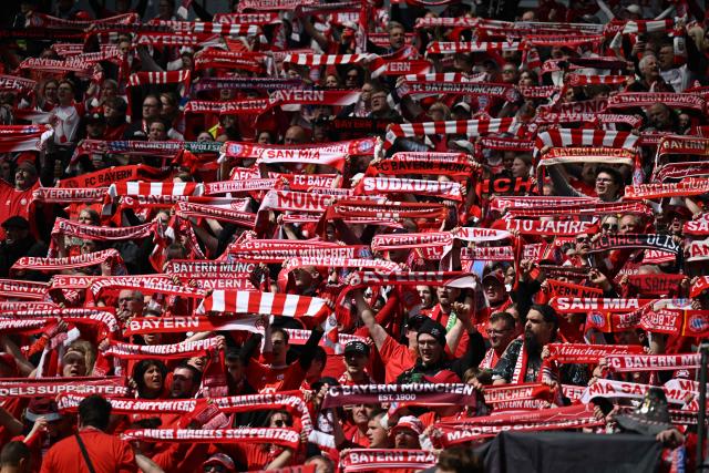 FC Bayern Munich fans cheer for their team prior to the start of the Women's German Cup (DFB-Pokal) final football match between VfL Wolfsburg and FC Bayern Munich in Cologne, western Germany, on Mai 14, 2026. (Photo by INA FASSBENDER / AFP) / DFB REGULATIONS PROHIBIT ANY USE OF PHOTOGRAPHS AS IMAGE SEQUENCES AND QUASI-VIDEO.