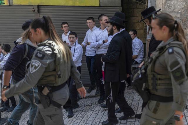 Israeli police personnel patrol along the old city of Jerusalem, during the Jerusalem Day parade on May 14, 2026. Every year, thousands of Israeli nationalists, many of them religious Jews, march through Jerusalem and its annexed Old City, including in predominantly Palestinian neighbourhoods, waving Israeli flags, dancing and sometimes shouting inflammatory slogans. (Photo by ilia YEFIMOVICH / AFP)