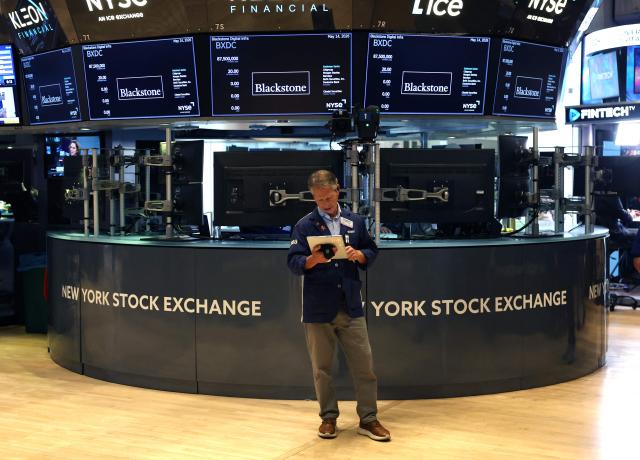 A trader works on the floor of the New York Stock Exchange (NYSE) at the opening bell in New York on May 14, 2026. Wall Street stocks rose early Thursday on positive sentiment about the US-China summit and strong Cisco earnings that reinforced confidence in artificial intelligence growth. (Photo by TIMOTHY A. CLARY / AFP)