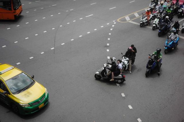 Motorists wait for the lights to change on a main road in Bangkok on May 14, 2026. (Photo by ANTHONY WALLACE / AFP)