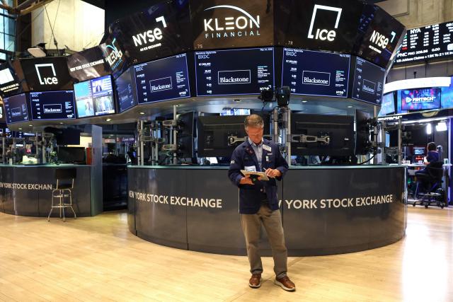 A trader works on the floor of the New York Stock Exchange (NYSE) at the opening bell in New York on May 14, 2026. Wall Street stocks rose early Thursday on positive sentiment about the US-China summit and strong Cisco earnings that reinforced confidence in artificial intelligence growth. (Photo by TIMOTHY A. CLARY / AFP)