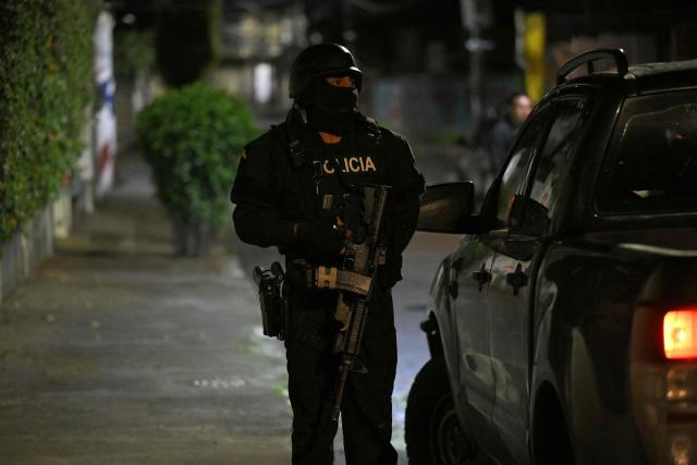 A police officer takes part in an operation to arrest Eduardo Gomez, alias "Gordo Paul", during a curfew imposed by President Daniel Noboa to tackle organized crime, in Quito in the early hours of May 14, 2026. Ecuador's police on May 14 captured a "dangerous" leader of Los Lobos, the country's largest drug trafficking group, in a cinematic operation led by Interior Minister Jhon Reimberg, AFP reporters witnessed. (Photo by AFP)