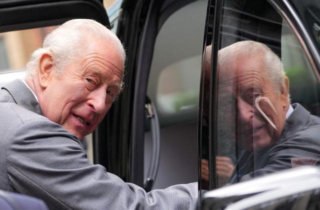 Britain's King Charles III is reflected as he steps into a car after meeting students in National Youth Music Theatre workshops in south west London on May 14, 2026, to celebrate the 50th anniversary of the arts organisation. (Photo by Kin Cheung / POOL / AFP)