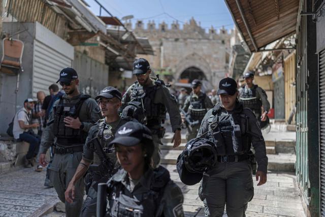 Israeli police personnel patrol along the old city of Jerusalem, during the Jerusalem Day parade on May 14, 2026. Every year, thousands of Israeli nationalists, many of them religious Jews, march through Jerusalem and its annexed Old City, including in predominantly Palestinian neighbourhoods, waving Israeli flags, dancing and sometimes shouting inflammatory slogans. (Photo by ilia YEFIMOVICH / AFP)