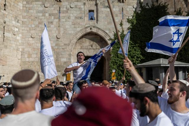 Israeli settlers take part in the Jerusalem Day parade at the Damascus Gate in the old city of Jerusalem on May 14, 2026. Every year, thousands of Israeli nationalists, many of them religious Jews, march through Jerusalem and its annexed Old City, including in predominantly Palestinian neighbourhoods, waving Israeli flags, dancing and sometimes shouting inflammatory slogans. (Photo by ilia YEFIMOVICH / AFP)