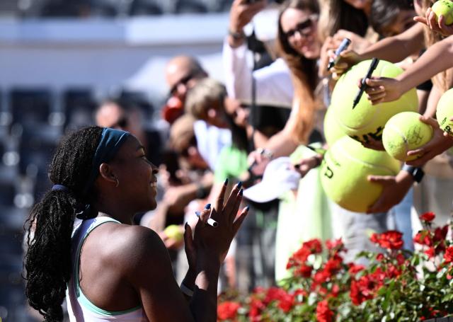 USA's Coco Gauff sign autographs after winning against Romania's Sorana Cirstea during the ATP Rome Open tennis tournament at Foro Italico in Rome on May 14, 2026. (Photo by Tiziana FABI / AFP)
