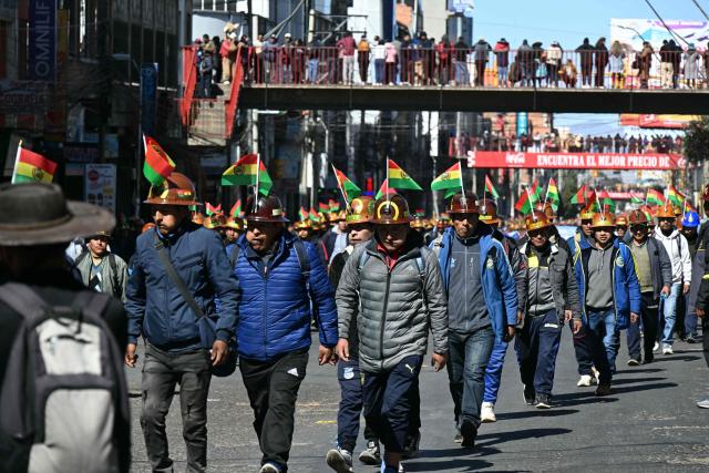 Miners march to La Paz in demand of Bolivia's President Rodrigo Paz's resignation in El Alto, Bolivia, on May 14, 2026. For the past two weeks, workers, farmers, school teachers, Indigenous groups and transport workers have been pressuring the government. Their demands range from wage increases and economic stabilization to opposition to the privatization of public companies. (Photo by AIZAR RALDES / AFP)