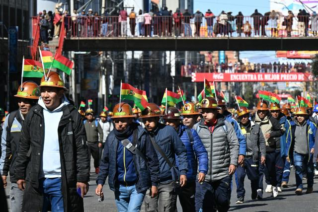 Miners march to La Paz in demand of Bolivia's President Rodrigo Paz's resignation in El Alto, Bolivia, on May 14, 2026. For the past two weeks, workers, farmers, school teachers, Indigenous groups and transport workers have been pressuring the government. Their demands range from wage increases and economic stabilization to opposition to the privatization of public companies. (Photo by AIZAR RALDES / AFP)