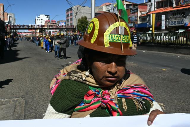 Miners march to La Paz in demand of Bolivia's President Rodrigo Paz's resignation in El Alto, Bolivia, on May 14, 2026. For the past two weeks, workers, farmers, school teachers, Indigenous groups and transport workers have been pressuring the government. Their demands range from wage increases and economic stabilization to opposition to the privatization of public companies. (Photo by AIZAR RALDES / AFP)